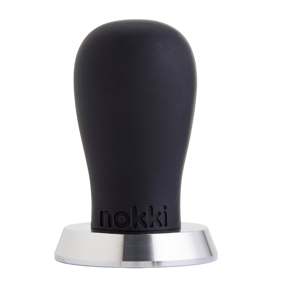 A Nokki 51mm coffee tamper with a matte black silicone handle and a machined 316 stainless steel base, shown on a solid white background.