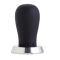 A Nokki 51mm coffee tamper with a matte black silicone handle and a machined 316 stainless steel base, shown on a solid white background.