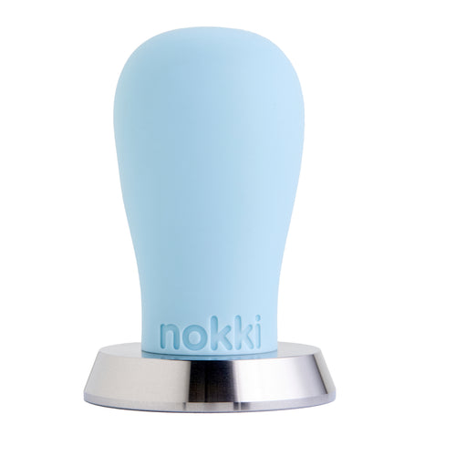 A Nokki 51mm coffee tamper with a matte blue silicone handle and a machined 316 stainless steel base, shown on a solid white background.
